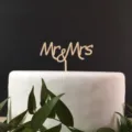 Close-up detail of the rustic wooden Mr and Mrs cake topper showcasing fine wood texture. - Style 5