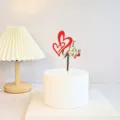 Acrylic Valentine cake topper with double hearts and gold love text, ideal for romantic party. - Heart I Love You