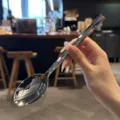 Detailed view of mirror polished stainless steel spoon with sophisticated diamond cut handle. - Dinner Spoon