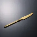 Gold stainless steel steak knife with serrated blade and elegant classical handle design. - Gold Knife