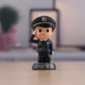Closeup view of the miniature resin police figurine, featuring detailed uniform and a saluting pose. - Little Policeman - Boy Style