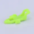 Detailed view of the fluorescent green plastic fishing hook keeper for outdoor rods. - Green