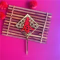 Detail view of golden acrylic Chinese New Year cake topper with red Chun character design. - Spring Character (Red) / Red