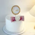 Elegant cake topper detail featuring Queen text, golden beads, and a chic white flower bow. - Pink Bowknot Topper