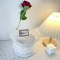 Detail view of mother's day decorative cake with queen topper, white tulle and pearls. - Square Queen Topper
