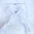 Close-up detail of a white organza ribbon bow with a sparkling rhinestone center for decor. - Organza Bow Rhinestone Decoration
