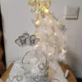 Cake topper set with fairy lights, elegant white flowers and ribbon for party decor. - Glowing Birdcage Cake Decoration Set / Gold