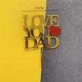 Gold acrylic Father's Day cake topper with LOVE YOU DAD text and red heart decoration. - Love You Dad Gold Lettering