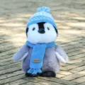 Cute plush penguin toy wearing a blue knitted hat and scarf, perfect soft birthday gift for kids. - 18cm / Blue