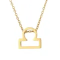 Gros plan détaillé du collier pendentif signe astrologique Balance doré, texture métal. - Signe du zodiaque Balance