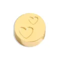 Close-up detail of a gold stainless steel round DIY charm bead with engraved double heart design. - Perforated Double Heart