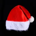 Classic red plush Christmas hat with white fluffy trim and pom pom for holiday party wear. - Short Plush