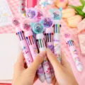 Close up of colorful 10-in-1 unicorn ballpoint pens with glitter floating caps and cute design. - 0.5mm Bullet Tip / Rainbow Unicorn (Random)
