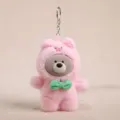 Cute plush bear keychain in pink pig costume with green bow tie, stylish bag charm variant. - Vinyl Bear Transformed into Pig - Pink