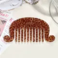 Detailed shot of tortoiseshell wide tooth hair comb, acetate vintage wave design detail. - Brown Polka Dot