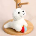 Cute plush seal keychain holding a colorful ball, perfect bag charm and toy gift. - Seal Holding Ball