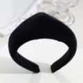 Detailed view of the black velvet padded headband, showing the soft fabric texture. - Headband Style / Black