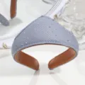 Detail shot of a grey crown-shaped rhinestone fabric headband with brown leather lining. - Rhinestone Grey