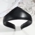 Close-up detail shot of the black leather crown headband, showing smooth texture and pointed design. - Basic Leather Black