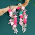 Detailed view of long floral tassel earrings featuring pink resin roses and sparkling crystals. - Rose Drop Style