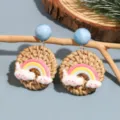 Boho handmade rattan woven earrings with cute resin rainbow cloud charms and blue beads. - Rainbow