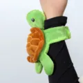 Cute green turtle plush slap bracelet for kids, soft animal wrist toy for party favors. - Turtle Snap Bracelet / Approx. 14cm