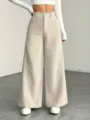 Close-up detail of high-waist beige corduroy wide-leg trousers, soft textured fabric. - M / Off White