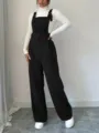 Black corduroy overalls paired with white ribbed turtleneck sweater detail view, casual style. - S / Black