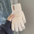 Closeup detail of winter touchscreen knit gloves in beige showing fingertip conductivity and label. - Vertical Label Split Finger / Beige