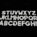 Close-up detail of sparkling rhinestone crystal alphabet letters pendant charms accessory. - Full Rhinestone Letter