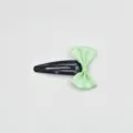Detailed shot of a sweet ribbon bow girl BB hair clip in light green, cute daily accessory. - Green