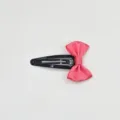 Close-up detail of black metal snap hair clip decorated with pink satin bow hair accessory detail. - Watermelon red