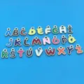 Close-up detail shot of colorful enamel 26 English letter metal charms, DIY jewelry accessories. - Set of 26 / Gold