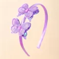 Detail view of purple satin headband with embroidered lace butterflies and sequins hair accessory - Purple