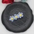 Close-up detail view of cute embroidered flower hair clip featuring blue petals and yellow center. - Blue Yellow Center Triple Flower (14#)
