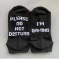 Close-up detail of black cotton casual socks featuring funny knitted white letter text design. - Style 3 (Ankle)