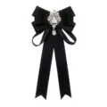 Detailed view of elegant black ribbon bow brooch with sparkling rhinestones and pearl pendant. - Black