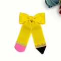 Close-up detail of the yellow ribbon pencil hair bow, featuring a cute back-to-school design. - Yellow