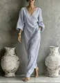 Close-up view of striped V-neck long dress detail, showing resort style and elegant lantern sleeves. - S / Dresses / Sky Blue