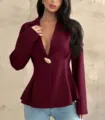 Detail view of a stylish slim fit maroon peplum blazer with unique button, fashion top. - Tops / Dark Red / S