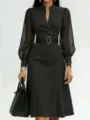 Detailed view of a stylish black denim long sleeve dress with sheer sleeves and wide belt. - S / Dresses / Black