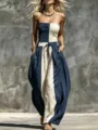 Detailed view of the strapless color-block jumpsuit with smocked bodice and wide legs. - S / Navy Blue