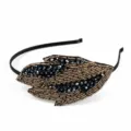 Detailed view of the 1920s vintage beaded leaf headband with sparkling crystals for elegant events. - Leaf Shape (HD6059) / Black & Gold
