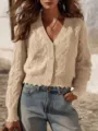 Close-up detail of beige cable knit cardigan with V-neck, buttons and chic raw hem design. - S / Tops / Off White