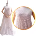 Cotton embroidered fabric detail showing hollow small flower pattern on white cotton lace. - Apricot