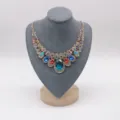 Gold-tone statement rhinestone necklace featuring vibrant multi-color crystal drops. - L / Gray