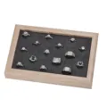 Solid wood jewelry display tray featuring dark velvet slotted pad with various shiny rings. - White Wood Grain with Grey Velvet Interior