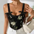 Detailansicht eines vintage blumigen Korsett-Tops mit eleganten Schleifen und Slim Fit. - S / Schwarz