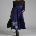 Detailed view of the women's color-blocked long sleeve maxi dress with dandelion print. - S / Blue