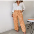 Chic summer two-piece outfit featuring a white long-sleeve shirt and bold printed wide-leg pants. - 3XL / Top And Bottom / Orange
